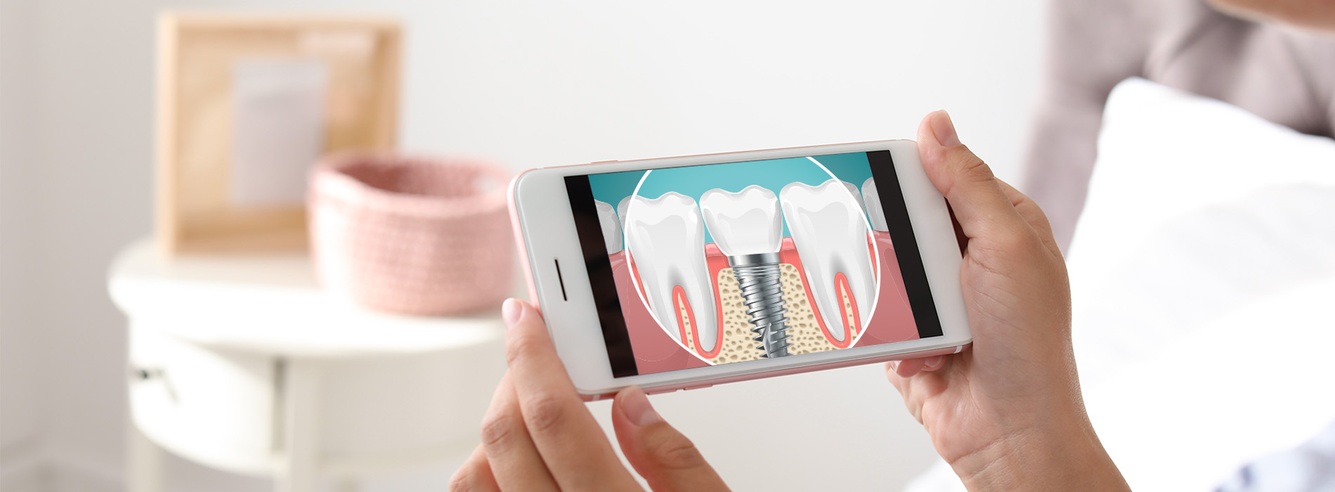 The image shows a person s hand holding a smartphone displaying an animated scene with a character performing dental hygiene, set against a blurred background that includes a table and what appears to be a personal care item.