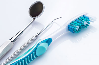 Toothbrushes and dental tools on a white background.