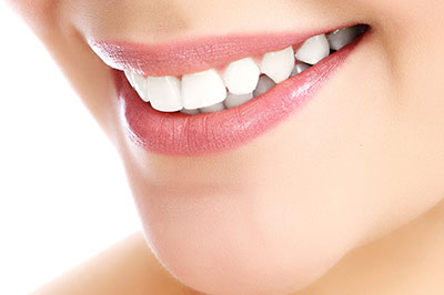 An image of a person with a bright smile, showcasing dental care products or services.