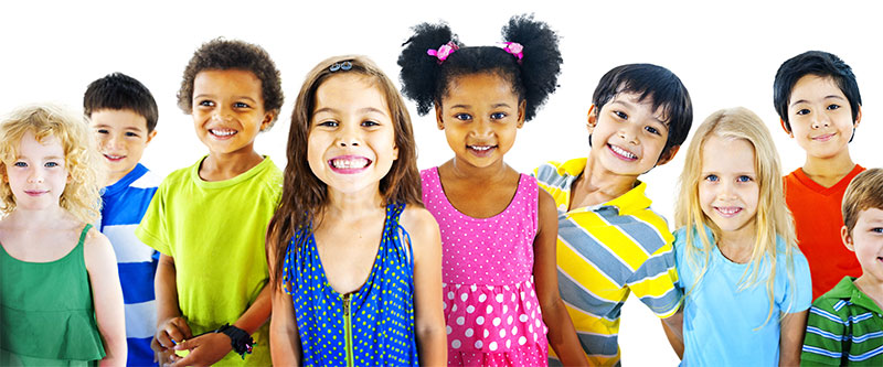 A group of children in colorful clothing, smiling and posing for a photo.