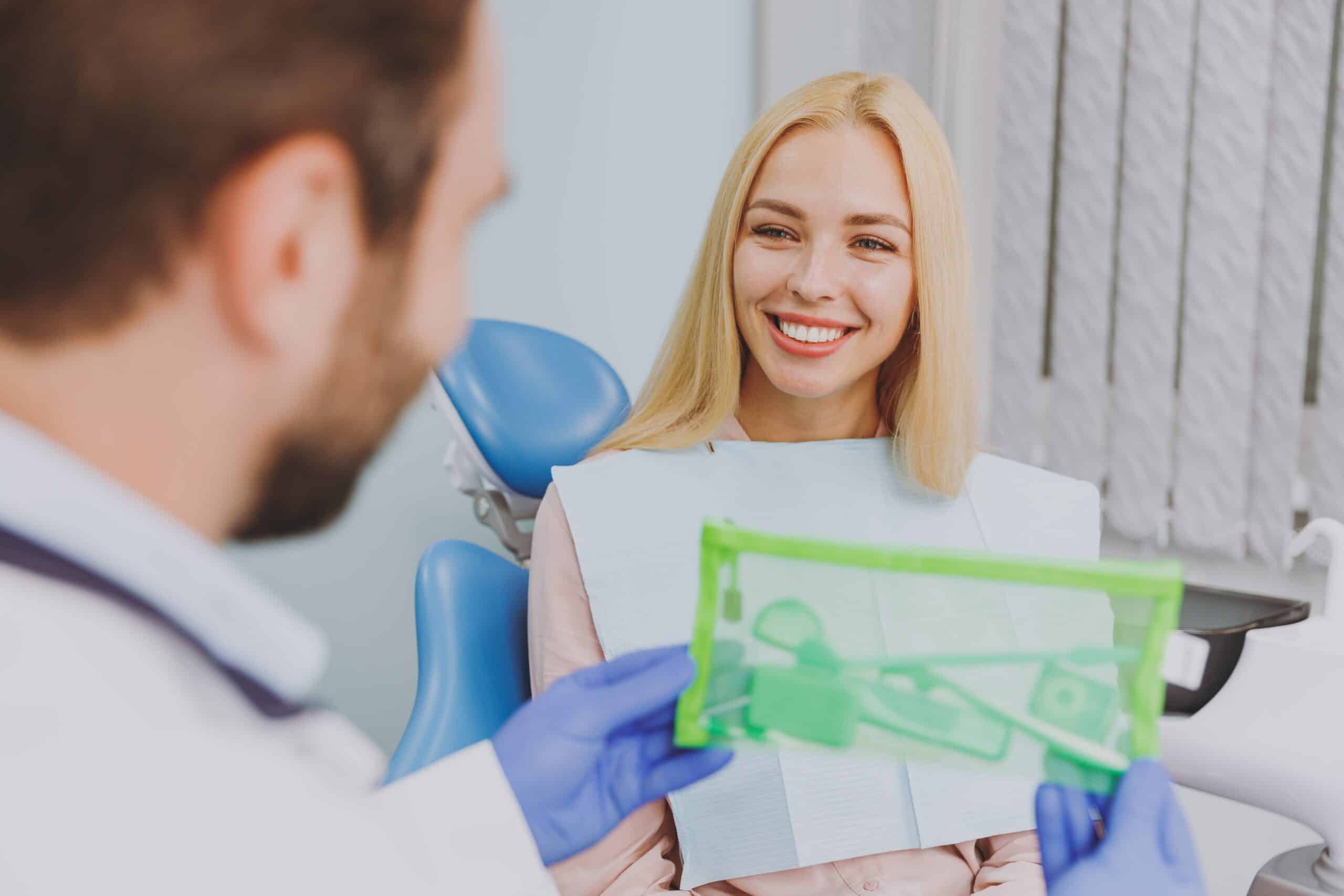 Close,Up,Stomatologist,Young,Man,Doctor,In,Gown,Give,Kit