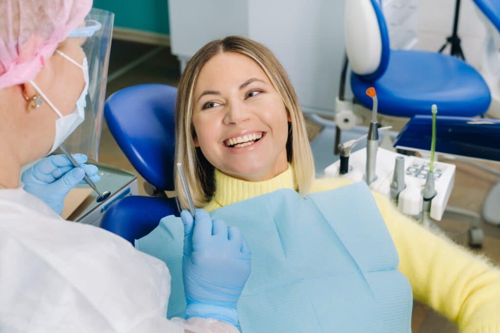 The,Girl,Smiles,At,The,Dentist,And,Looks,At,Her.