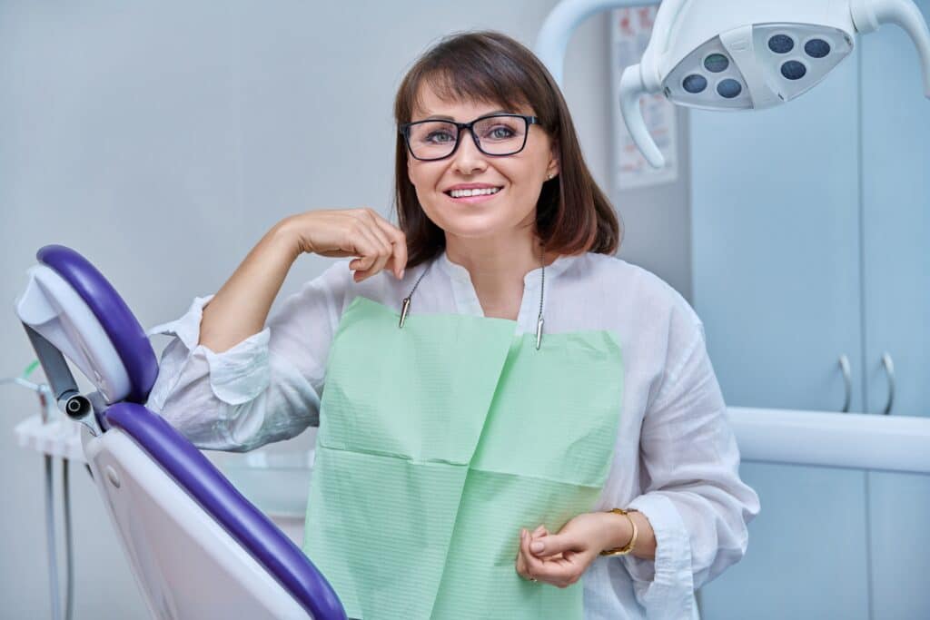 Happy,Middle,Aged,Woman,Patient,Looking,At,Camera,Sitting,In