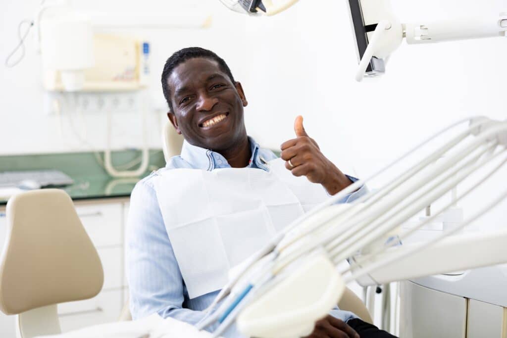 Smiling,Satisfied,Man,In,Dental,Chair,After,Surgery