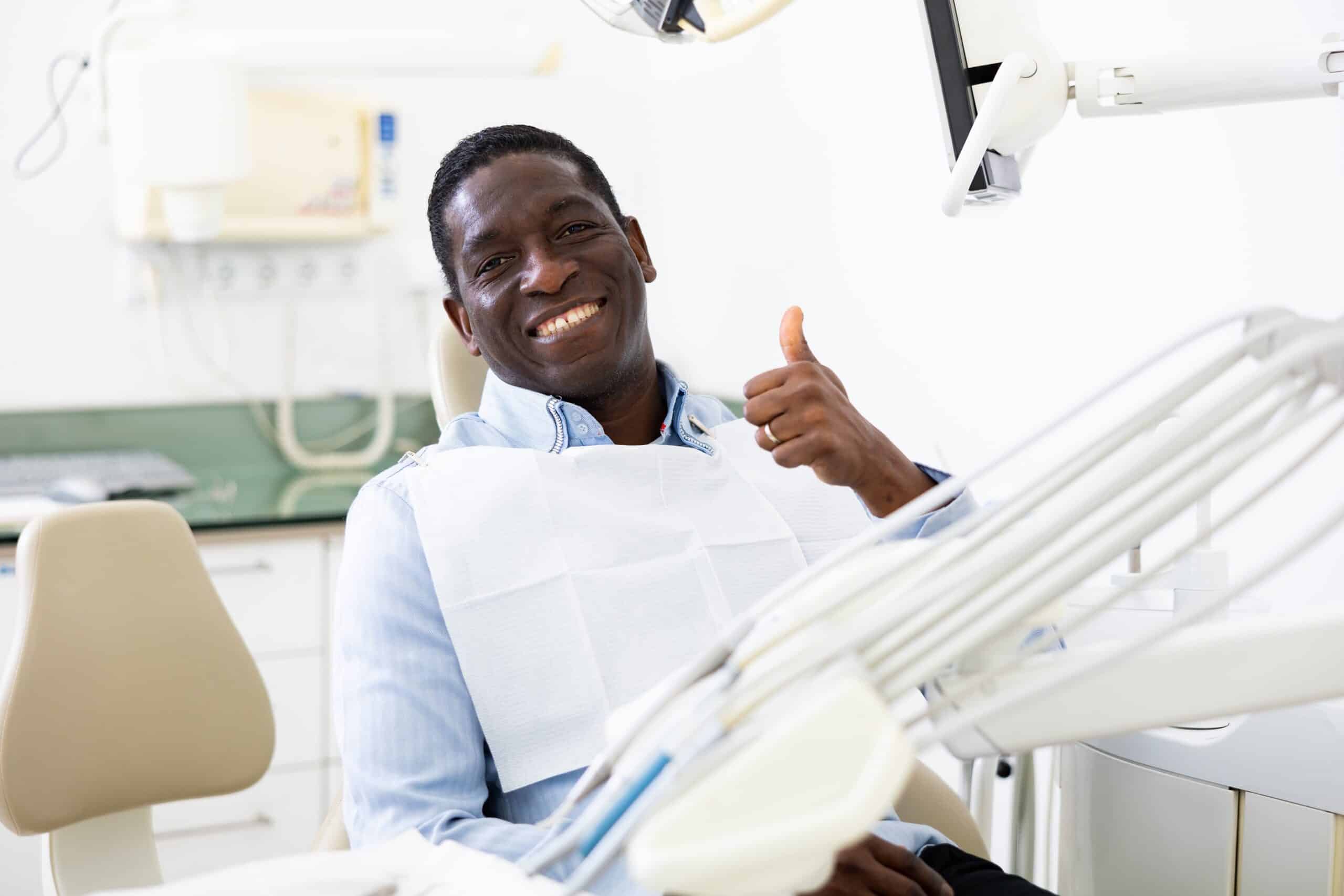 Smiling,Satisfied,Man,In,Dental,Chair,After,Surgery